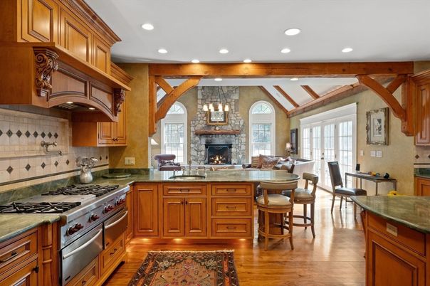 Fireplace, Interior, Kitchen, Living room, Pendant Lights, Recessed Lighting, Stainless Steel Appliances, Stone Walls, Wooden Beams, Wood Texture Flooring