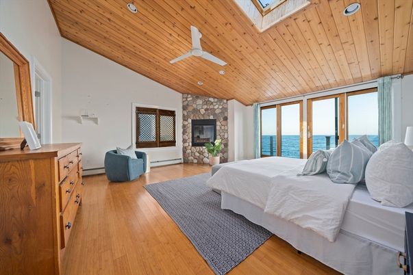 Bedroom, Fireplace, Interior, Recessed Lighting, Stone Walls, Water, Wooden Ceilings, Wood Texture Flooring