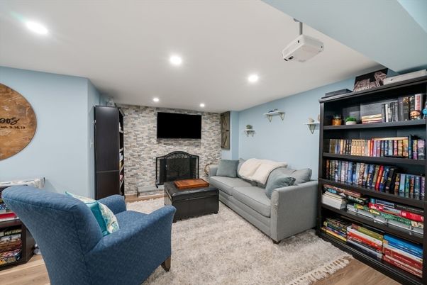Fireplace, Interior, Living room, Recessed Lighting, Stone Walls, Wood Texture Flooring