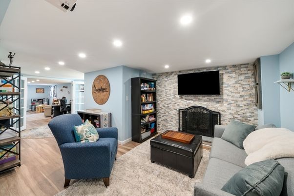 Dining room, Fireplace, Interior, Living room, Recessed Lighting, Stone Walls, Wood Texture Flooring