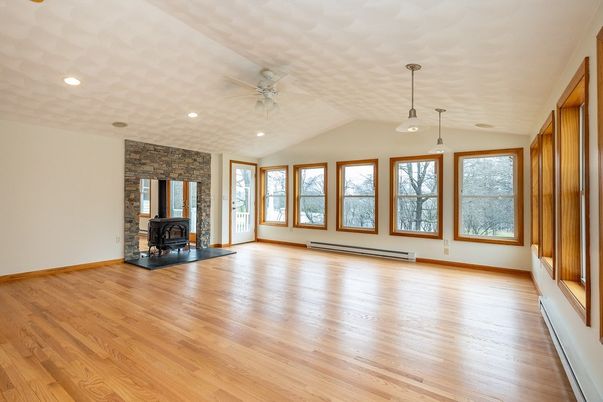 Empty room, Fireplace, Interior, Pendant Lights, Recessed Lighting, Stone Walls, Wood Texture Flooring