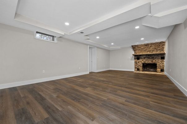 Empty room, Fireplace, Interior, Recessed Lighting, Stone Walls, Wood Texture Flooring