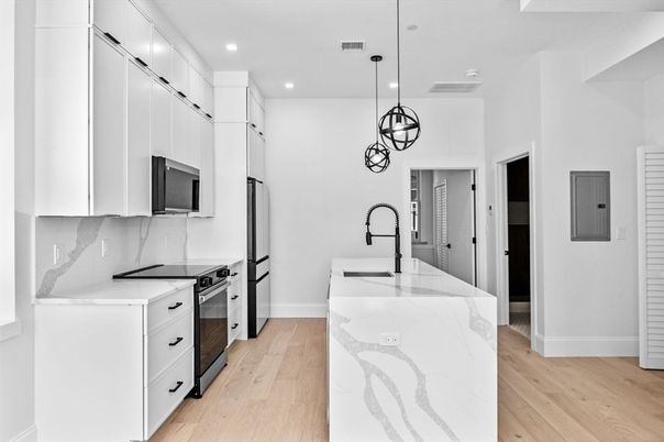 Interior, Kitchen, Marble Walls, Pendant Lights, Recessed Lighting, Stainless Steel Appliances, Wood Texture Flooring