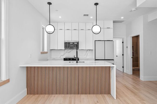 Interior, Kitchen, Marble Walls, Pendant Lights, Recessed Lighting, Stainless Steel Appliances, Wood Texture Flooring