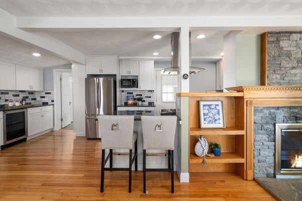 Fireplace, Interior, Kitchen, Recessed Lighting, Stainless Steel Appliances, Stone Walls, Wood Texture Flooring