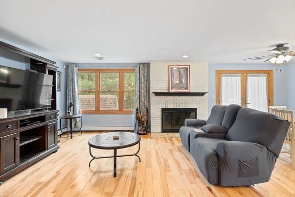 Fireplace, Interior, Living room, Recessed Lighting, Stone Walls, Wood Texture Flooring