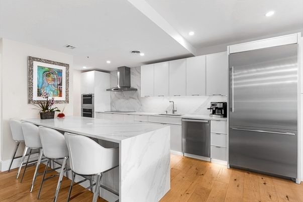Interior, Kitchen, Marble Walls, Recessed Lighting, Stainless Steel Appliances, Wood Texture Flooring