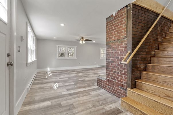 Empty room, Fireplace, Interior, Recessed Lighting, Stone Walls, Wood Texture Flooring