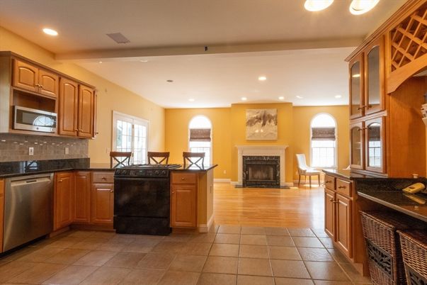 Fireplace, Interior, Kitchen, Recessed Lighting, Stainless Steel Appliances, Wood Texture Flooring