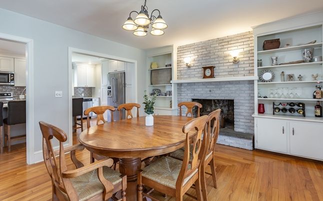 Dining room, Fireplace, Interior, Kitchen, Pendant Lights, Stainless Steel Appliances, Stone Walls, Wood Texture Flooring