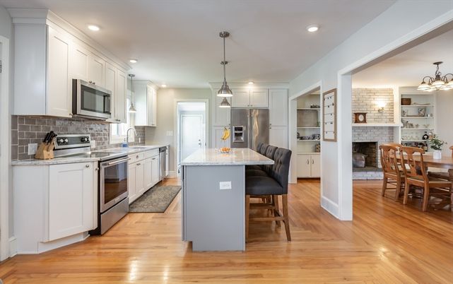 Dining room, Fireplace, Interior, Kitchen, Pendant Lights, Recessed Lighting, Stainless Steel Appliances, Stone Walls, Wood Texture Flooring