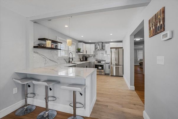 Interior, Kitchen, Marble Walls, Pendant Lights, Recessed Lighting, Stainless Steel Appliances, Wood Texture Flooring