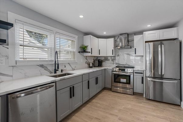 Interior, Kitchen, Marble Walls, Recessed Lighting, Stainless Steel Appliances, Wood Texture Flooring