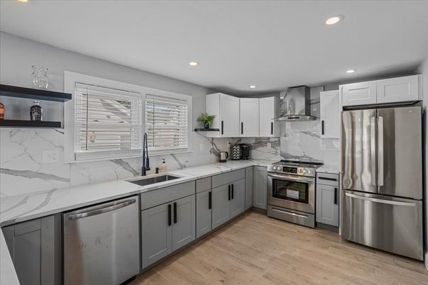 Interior, Kitchen, Marble Walls, Recessed Lighting, Stainless Steel Appliances, Wood Texture Flooring