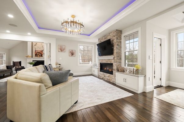 Chandelier, Fireplace, Interior, Living room, Recessed Lighting, Stone Walls, Wood Texture Flooring