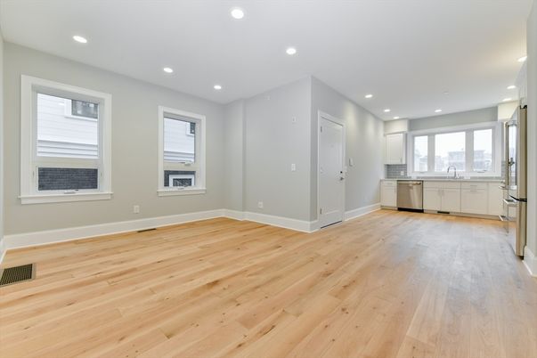 Empty room, Interior, Kitchen, Recessed Lighting, Stainless Steel Appliances, Wood Texture Flooring