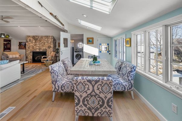 Dining room, Fireplace, Interior, Living room, Recessed Lighting, Stone Walls, Wood Texture Flooring