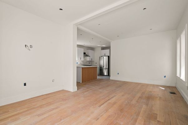 Empty room, Interior, Kitchen, Recessed Lighting, Stainless Steel Appliances, Wood Texture Flooring