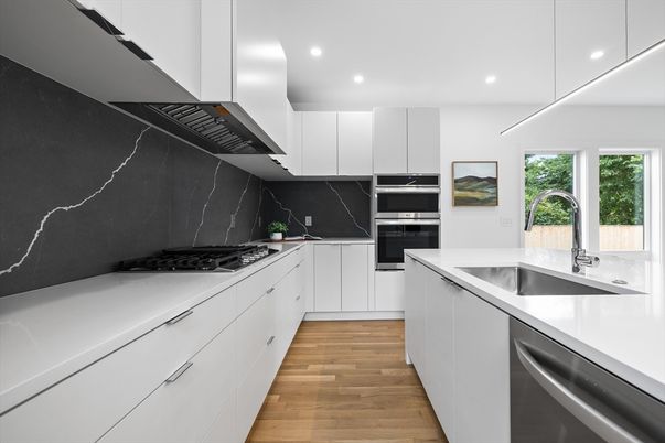 Interior, Kitchen, Marble Walls, Recessed Lighting, Stainless Steel Appliances, Wood Texture Flooring