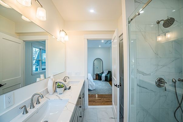 Bathroom, Dual Sink Vanities, Glass Shower, Interior, Marble, Marble Walls, Recessed Lighting, Wood Texture Flooring