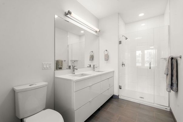 Bathroom, Dual Sink Vanities, Glass Shower, Interior, Recessed Lighting, Wood Texture Flooring