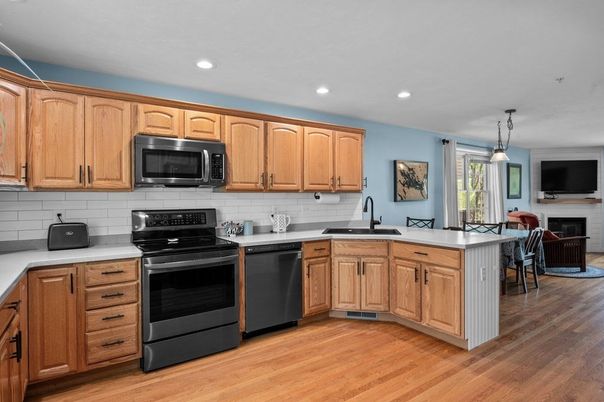 Dining room, Fireplace, Interior, Kitchen, Pendant Lights, Recessed Lighting, Stainless Steel Appliances, Wood Texture Flooring