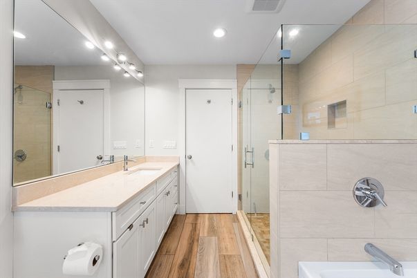 Bathroom, Dual Sink Vanities, Glass Shower, Interior, Recessed Lighting, Wood Texture Flooring
