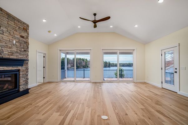 Empty room, Fireplace, Interior, Recessed Lighting, Stone Walls, Water, Wood Texture Flooring