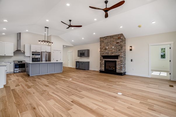 Chandelier, Empty room, Fireplace, Interior, Kitchen, Recessed Lighting, Stainless Steel Appliances, Wood Texture Flooring