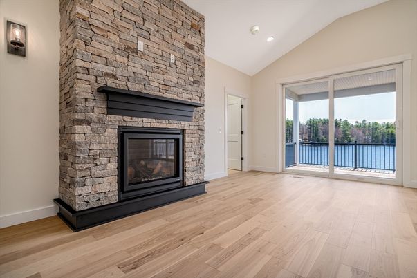 Empty room, Fireplace, Interior, Recessed Lighting, Stone Walls, Water, Wood Texture Flooring