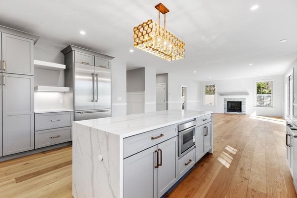 Chandelier, Fireplace, Interior, Kitchen, Recessed Lighting, Stainless Steel Appliances, Wood Texture Flooring