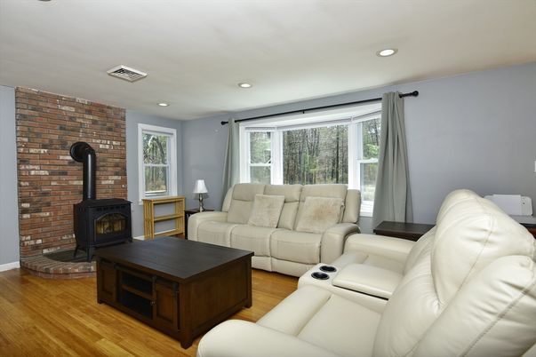 Fireplace, Interior, Living room, Recessed Lighting, Stone Walls, Wood Texture Flooring