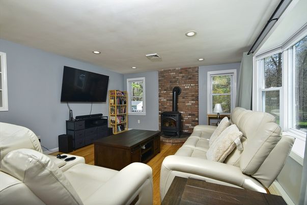 Fireplace, Interior, Living room, Recessed Lighting, Stone Walls, Wood Texture Flooring