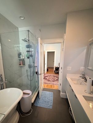 Bathroom, Dual Sink Vanities, Free Standing Baths, Glass Shower, Interior, Marble, Marble Walls, Recessed Lighting, Wood Texture Flooring