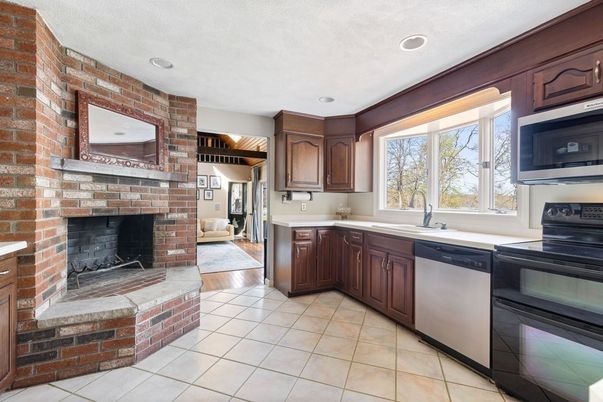 Fireplace, Interior, Kitchen, Recessed Lighting, Stone Walls, Wood Texture Flooring