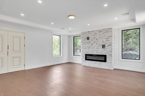 Empty room, Fireplace, Interior, Recessed Lighting, Stone Walls, Wood Texture Flooring