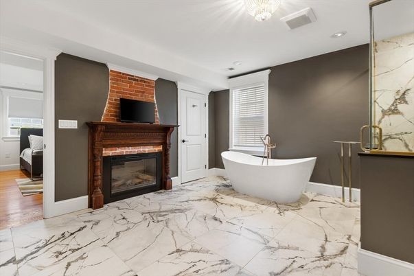 Bathroom, Fireplace, Free Standing Baths, Interior, Marble, Marble Walls, Recessed Lighting, Wood Texture Flooring