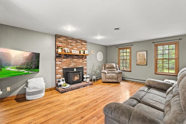 Fireplace, Interior, Living room, Recessed Lighting, Stone Walls, Wood Texture Flooring
