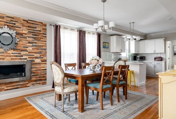 Chandelier, Dining room, Fireplace, Interior, Kitchen, Pendant Lights, Stainless Steel Appliances, Stone Walls, Wood Texture Flooring
