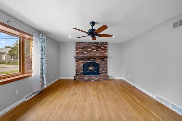 Empty room, Fireplace, Interior, Recessed Lighting, Stone Walls, Wood Texture Flooring