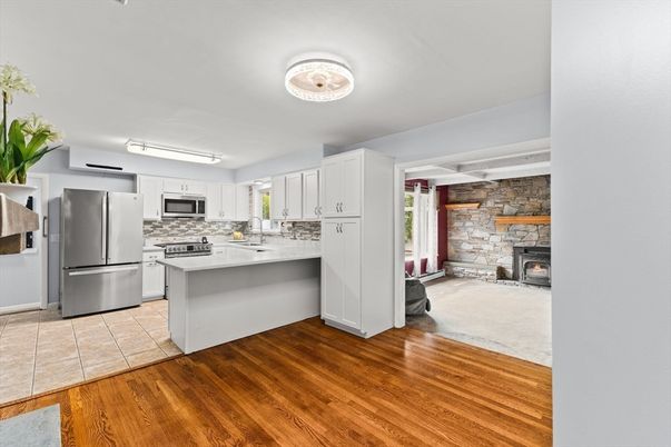Fireplace, Interior, Kitchen, Stainless Steel Appliances, Stone Walls, Wood Texture Flooring