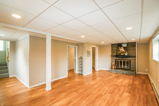 Empty room, Fireplace, Interior, Recessed Lighting, Stone Walls, Wood Texture Flooring