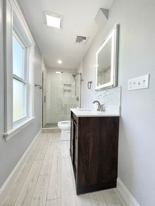 Bathroom, Dual Sink Vanities, Glass Shower, Interior, Recessed Lighting, Wood Texture Flooring