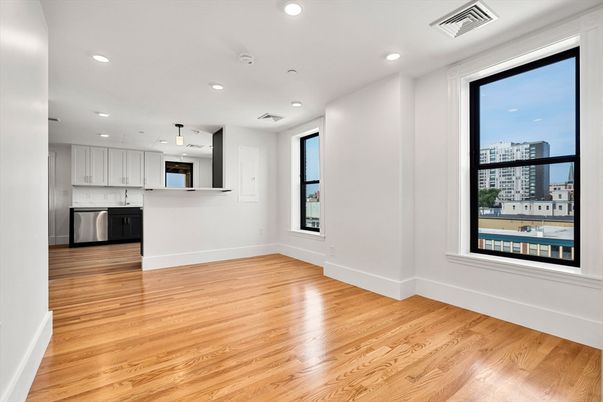 Empty room, Interior, Kitchen, Pendant Lights, Recessed Lighting, Stainless Steel Appliances, Wood Texture Flooring