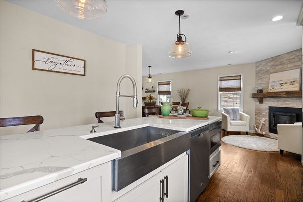 Fireplace, Interior, Kitchen, Living room, Pendant Lights, Recessed Lighting, Stainless Steel Appliances, Stone Walls, Wood Texture Flooring