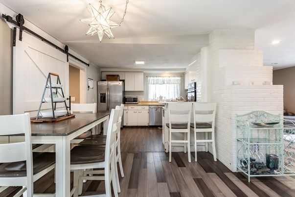 Dining room, Interior, Kitchen, Recessed Lighting, Stainless Steel Appliances, Stone Walls, Wood Texture Flooring