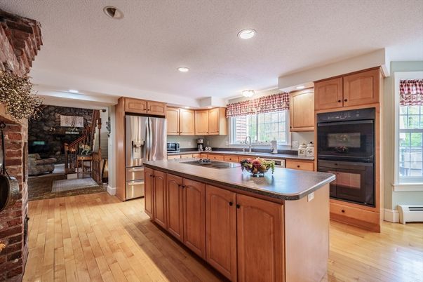 Dining room, Fireplace, Interior, Kitchen, Recessed Lighting, Stainless Steel Appliances, Stone Walls, Wood Texture Flooring
