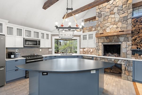 Fireplace, Interior, Kitchen, Pendant Lights, Stainless Steel Appliances, Stone Walls, Wooden Beams