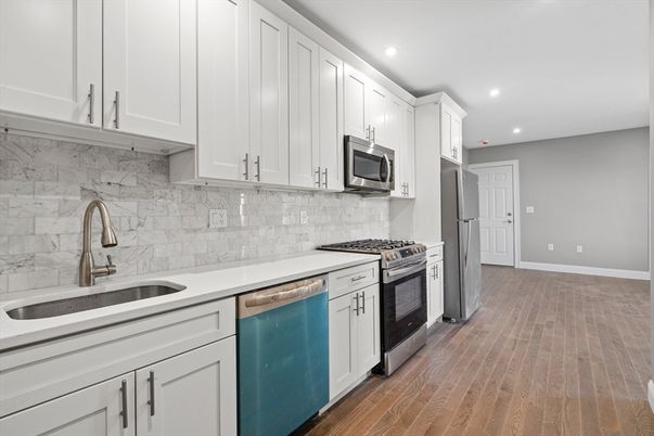 Interior, Kitchen, Marble Walls, Recessed Lighting, Stainless Steel Appliances, Wood Texture Flooring