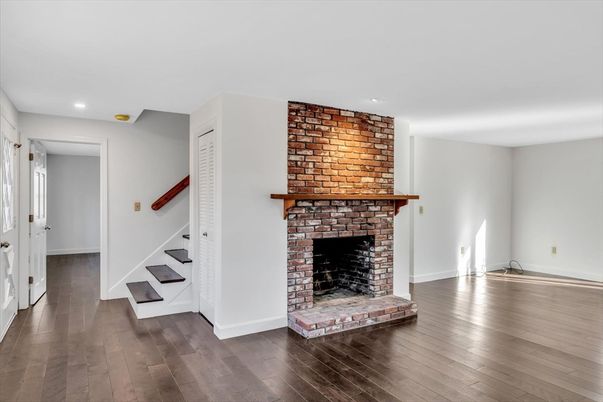 Empty room, Fireplace, Interior, Recessed Lighting, Stone Walls, Wood Texture Flooring